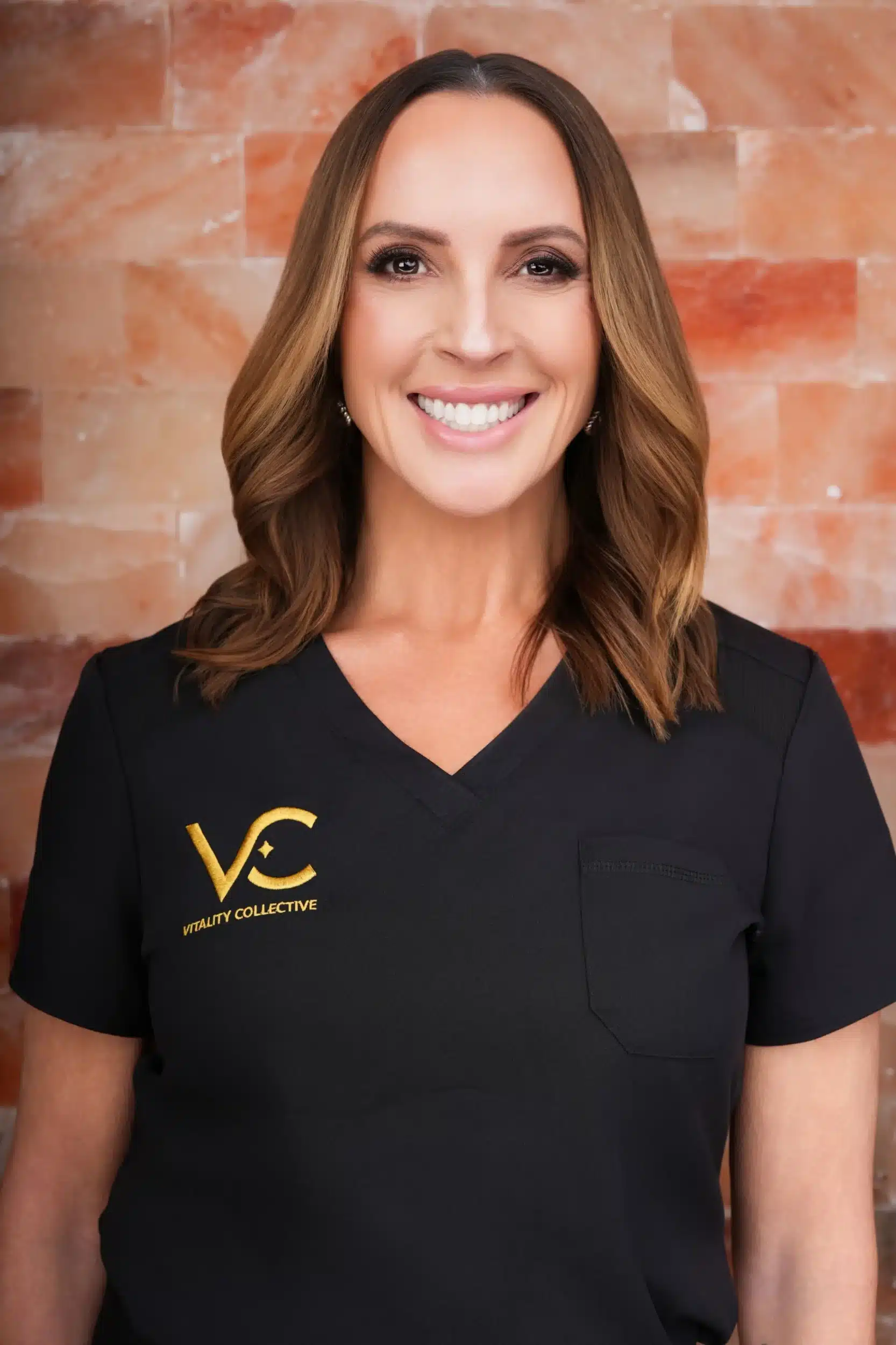 Vitality Collective staff member in uniform smiling.