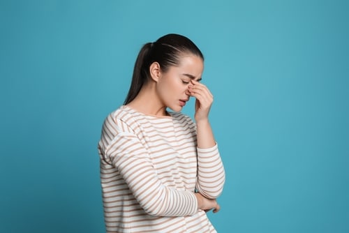 Person looking fatigued, possibly needing NAD peptide therapy.