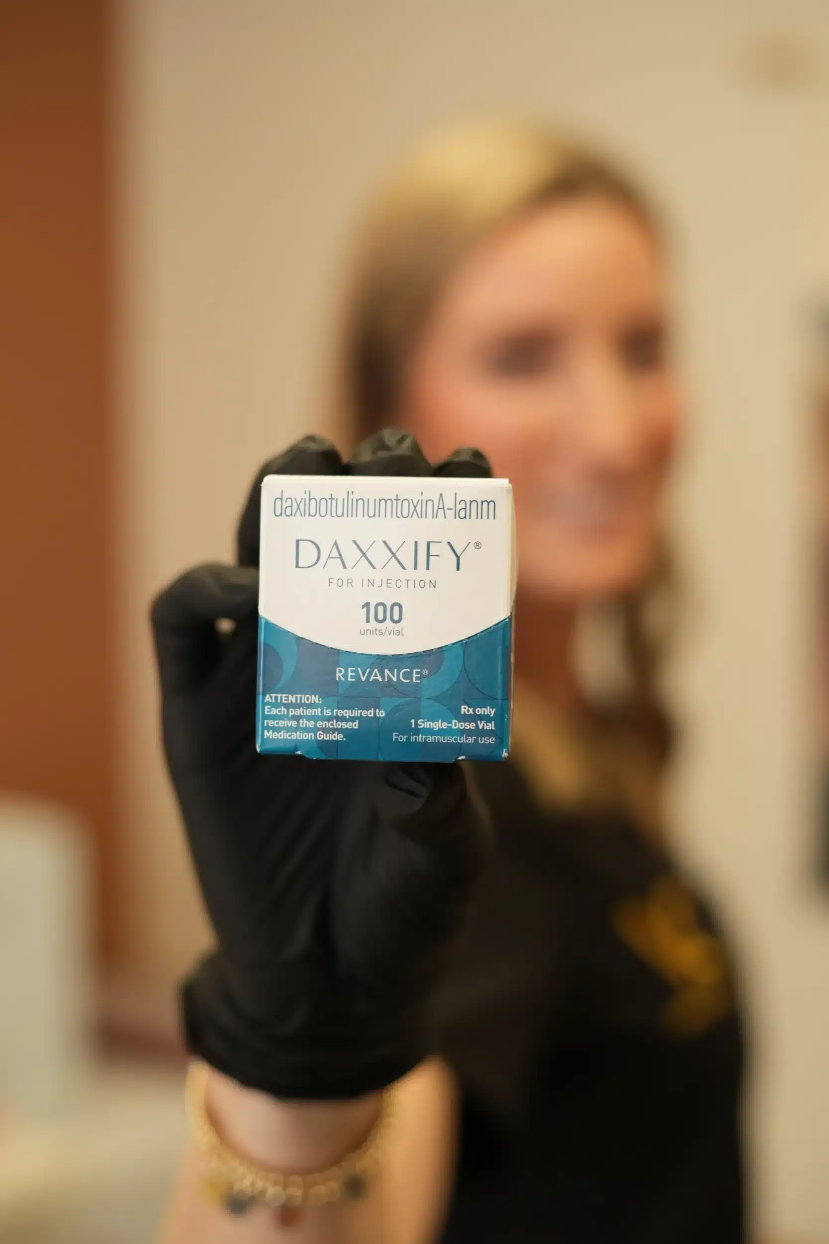 Vitality Collective staff holding Daxxify injection box.