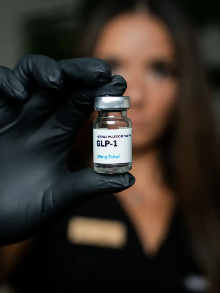 Maureen McSwiggin, APRN holding a GLP-1 vial.