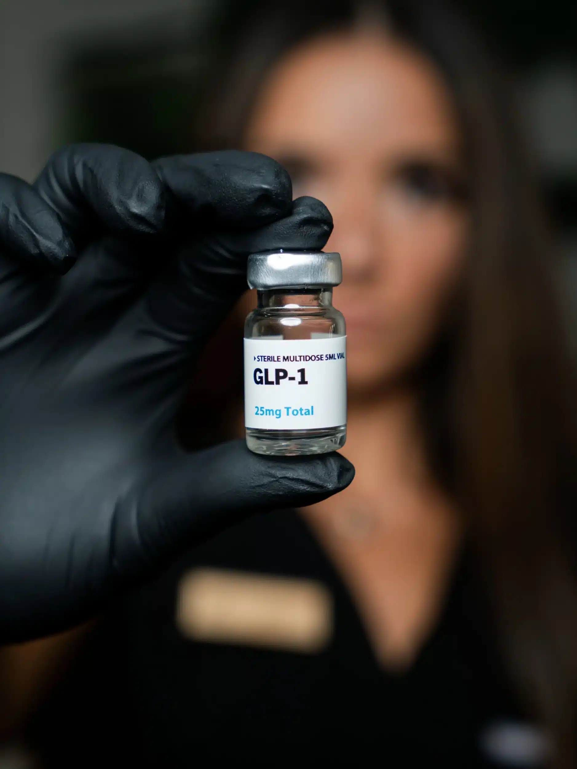 Maureen McSwiggin, APRN holding a GLP-1 vial.