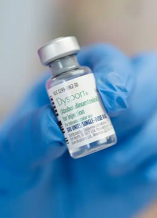 Dysport vial held by gloved hand at Vitality Collective.